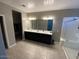 Large bathroom featuring double sinks, a vanity, and a walk-in shower at 29573 W Mitchell Ave, Buckeye, AZ 85396