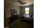 Cozy bedroom featuring a dresser, mirror, and queen-size bed with natural lighting at 29573 W Mitchell Ave, Buckeye, AZ 85396