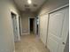 Hallway with tile flooring and white sliding door closet at 29573 W Mitchell Ave, Buckeye, AZ 85396