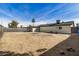 A backyard with dirt landscaping and a view of the home and a full fence at 3034 W San Miguel Ave, Phoenix, AZ 85017