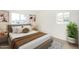 A cozy bedroom with white walls, neutral decor, and lots of natural light at 3034 W San Miguel Ave, Phoenix, AZ 85017