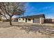 Charming home featuring a gravel front yard, a dark gray garage door, and beautiful curb appeal at 3034 W San Miguel Ave, Phoenix, AZ 85017