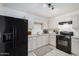 This kitchen offers white cabinets, black appliances, tile flooring, and a gas range at 3034 W San Miguel Ave, Phoenix, AZ 85017