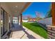 Expansive backyard view featuring a covered patio, pool, outdoor kitchen, and green lawn at 3312 E Sells Dr, Phoenix, AZ 85018