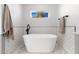 This bathroom features a standalone tub with black fixtures and a window with natural light at 3312 E Sells Dr, Phoenix, AZ 85018