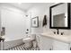 Well-appointed bathroom featuring a tub-shower, stylish vanity, modern fixtures, and decorative black and white floor tiles at 3312 E Sells Dr, Phoenix, AZ 85018