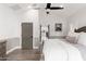 This main bedroom has wood floors, a vaulted ceiling, and white and gray paneled walls at 3312 E Sells Dr, Phoenix, AZ 85018