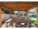 Beautiful outdoor kitchen with a full grill setup and sink underneath a gorgeous pergola at 3312 E Sells Dr, Phoenix, AZ 85018