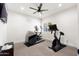 Inviting workout room features modern exercise equipment, natural light, ceiling fan, and inspirational wall art at 3312 E Sells Dr, Phoenix, AZ 85018