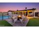 Evening shot of backyard featuring a fire pit, lounge chairs, and a sparkling pool at 3350 W Charter Oak Rd, Phoenix, AZ 85029