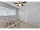 Bright bedroom featuring ceiling fan, and a double door closet at 3350 W Charter Oak Rd, Phoenix, AZ 85029