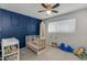 Charming Bedroom with crib, blue accent wall, and a play area at 3350 W Charter Oak Rd, Phoenix, AZ 85029