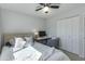 Bright bedroom featuring ceiling fan, double door closet, and a dedicated desk area at 3350 W Charter Oak Rd, Phoenix, AZ 85029