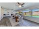 Dining area with a view of the pool, featuring stylish decor and a ceiling fan at 3350 W Charter Oak Rd, Phoenix, AZ 85029