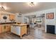 Bright kitchen with stainless steel appliances, wood cabinets, and a kitchen island opening to the living room at 3350 W Charter Oak Rd, Phoenix, AZ 85029