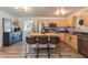 Well-lit kitchen featuring modern appliances, wooden cabinets, and a central island with barstool seating at 3350 W Charter Oak Rd, Phoenix, AZ 85029