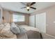 Comfortable main bedroom with neutral walls, ceiling fan, and a double door closet for ample storage at 3350 W Charter Oak Rd, Phoenix, AZ 85029