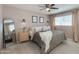 Stylish main bedroom featuring neutral walls, ceiling fan, and a window with bright natural light at 3350 W Charter Oak Rd, Phoenix, AZ 85029