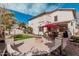 Spacious backyard with patio, fire pit, seating, lush lawn, and stucco exterior at 337 E Clairidge Dr, San Tan Valley, AZ 85143