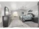 Bright bedroom with a gray color scheme, including a dresser, sitting nook, and tropical themed decorations at 337 E Clairidge Dr, San Tan Valley, AZ 85143