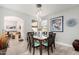 Stylish dining area with a modern table set, offering a view into the cozy living room at 337 E Clairidge Dr, San Tan Valley, AZ 85143