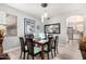 Elegant dining room with seating for six, adorned with modern light fixtures and decor at 337 E Clairidge Dr, San Tan Valley, AZ 85143