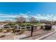 Scenic community entrance with white fencing, lush green spaces, and well-maintained landscaping at 337 E Clairidge Dr, San Tan Valley, AZ 85143