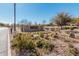 Landscaped community entrance sign with stone accents, white fence, and vibrant desert flowers at 337 E Clairidge Dr, San Tan Valley, AZ 85143