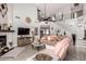 Spacious living room featuring a cozy pink couch and a stunning fireplace with stone accents at 337 E Clairidge Dr, San Tan Valley, AZ 85143