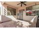 Covered patio with patterned concrete floors, a ceiling fan and a protective metal door at 337 E Clairidge Dr, San Tan Valley, AZ 85143