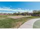 Community sand volleyball court surrounded by green grass and residential homes at 337 E Clairidge Dr, San Tan Valley, AZ 85143