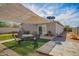 Backyard seating area with patio, synthetic grass, desert landscaping, and a lattice-covered patio at 354 W Bealey Ave, Coolidge, AZ 85128