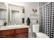 A modern bathroom with granite countertops, updated fixtures, and a stylish black and white checkered shower curtain at 354 W Bealey Ave, Coolidge, AZ 85128