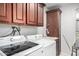 Efficient laundry room with modern appliances, ample storage, and a convenient sink for added functionality at 354 W Bealey Ave, Coolidge, AZ 85128