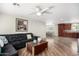 Spacious living room with modern wood-look floors and a comfortable sectional sofa at 354 W Bealey Ave, Coolidge, AZ 85128