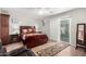 Comfortable main bedroom featuring wood floors, a ceiling fan, and sliding glass doors to the backyard at 354 W Bealey Ave, Coolidge, AZ 85128