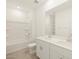 Well-lit bathroom featuring double sink vanity and shower-tub combo at 37056 W Prado St, Maricopa, AZ 85138