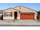 Beautiful single-Gathering home with well maintained front yard, complemented by the striking orange garage door and shutters at 37056 W Prado St, Maricopa, AZ 85138