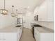 Bright kitchen featuring white cabinetry, stainless steel appliances, and granite countertops at 37056 W Prado St, Maricopa, AZ 85138