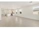 Bright living room with tile flooring, recessed lighting, and large windows for natural light at 37056 W Prado St, Maricopa, AZ 85138