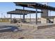 Rancho Mirage outdoor kitchen with BBQ and covered seating area for community gatherings at 37056 W Prado St, Maricopa, AZ 85138