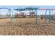 Rancho Mirage community playground with climbing structure and swingset at 37056 W Prado St, Maricopa, AZ 85138