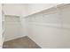 Spacious walk-in closet with ample shelving and carpeted floor at 37056 W Prado St, Maricopa, AZ 85138