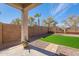 Landscaped backyard with synthetic grass and desert plants at 38672 N Establo Dr, San Tan Valley, AZ 85140