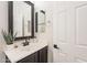 Bathroom vanity with dark wood cabinets and black hardware at 38672 N Establo Dr, San Tan Valley, AZ 85140