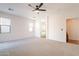 Carpeted bedroom featuring a ceiling fan and access to the bathroom, tub, and shower at 38672 N Establo Dr, San Tan Valley, AZ 85140