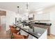 Spacious kitchen with an island, modern appliances, white cabinetry, and decorative pendant lights at 38672 N Establo Dr, San Tan Valley, AZ 85140