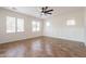 Bright living room with tile floors, modern ceiling fan, and large windows providing natural light at 38672 N Establo Dr, San Tan Valley, AZ 85140