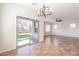 Open concept living room with tile floors, large windows, and a sliding glass door to the backyard at 38672 N Establo Dr, San Tan Valley, AZ 85140