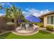 Backyard with pool, lounge chairs, artificial grass, and lush tropical landscaping at 3881 E Birchwood Pl, Chandler, AZ 85249